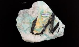 Turmaliin (mustad kristallid) ja amasoniit (rohekassinine mineraal)